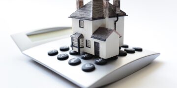 House on calculator concept for mortgage calculator, home finance or saving for a house loan